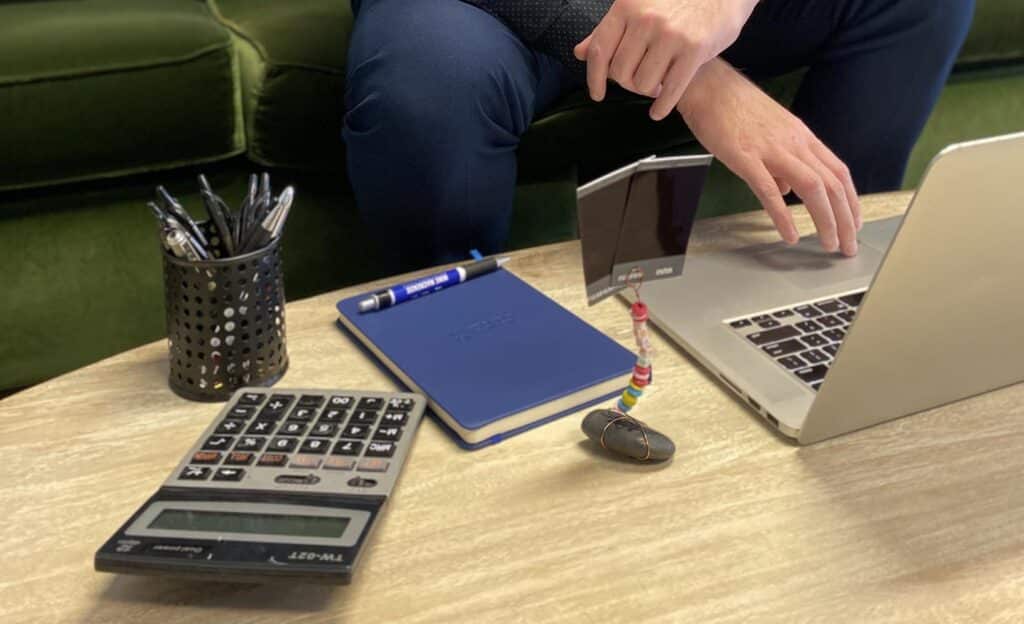 A close up of Mike Mackenzie working hard at his desk to reduce loan repayments