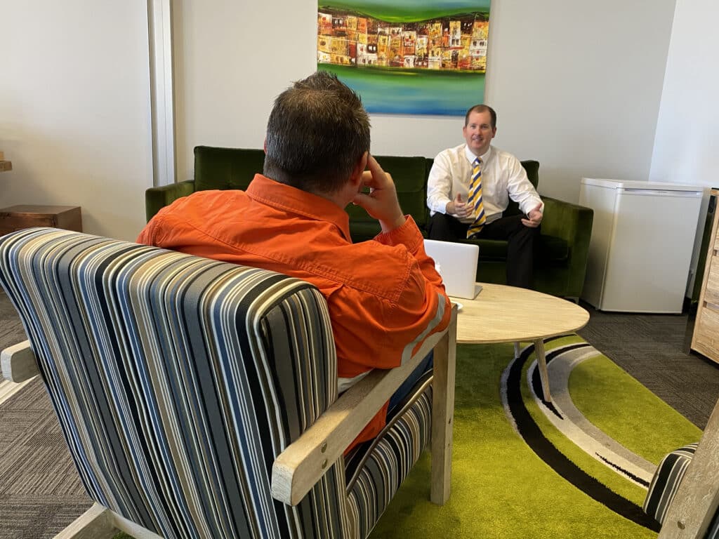 Mike Mackenzie; Perth Mortgage Broker, talking diligently to a client about his loan options